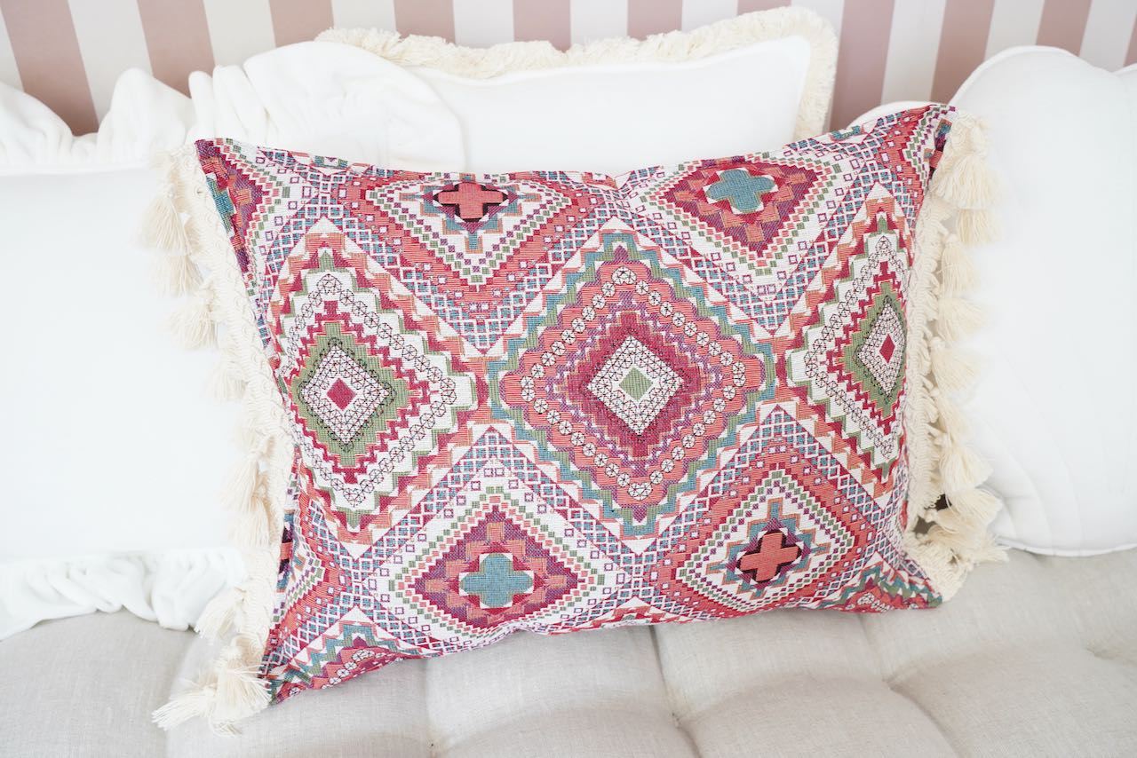 Pink boho style decorative pillow with fringe