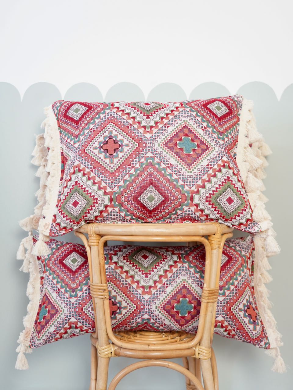 Pink boho style decorative pillow with fringe